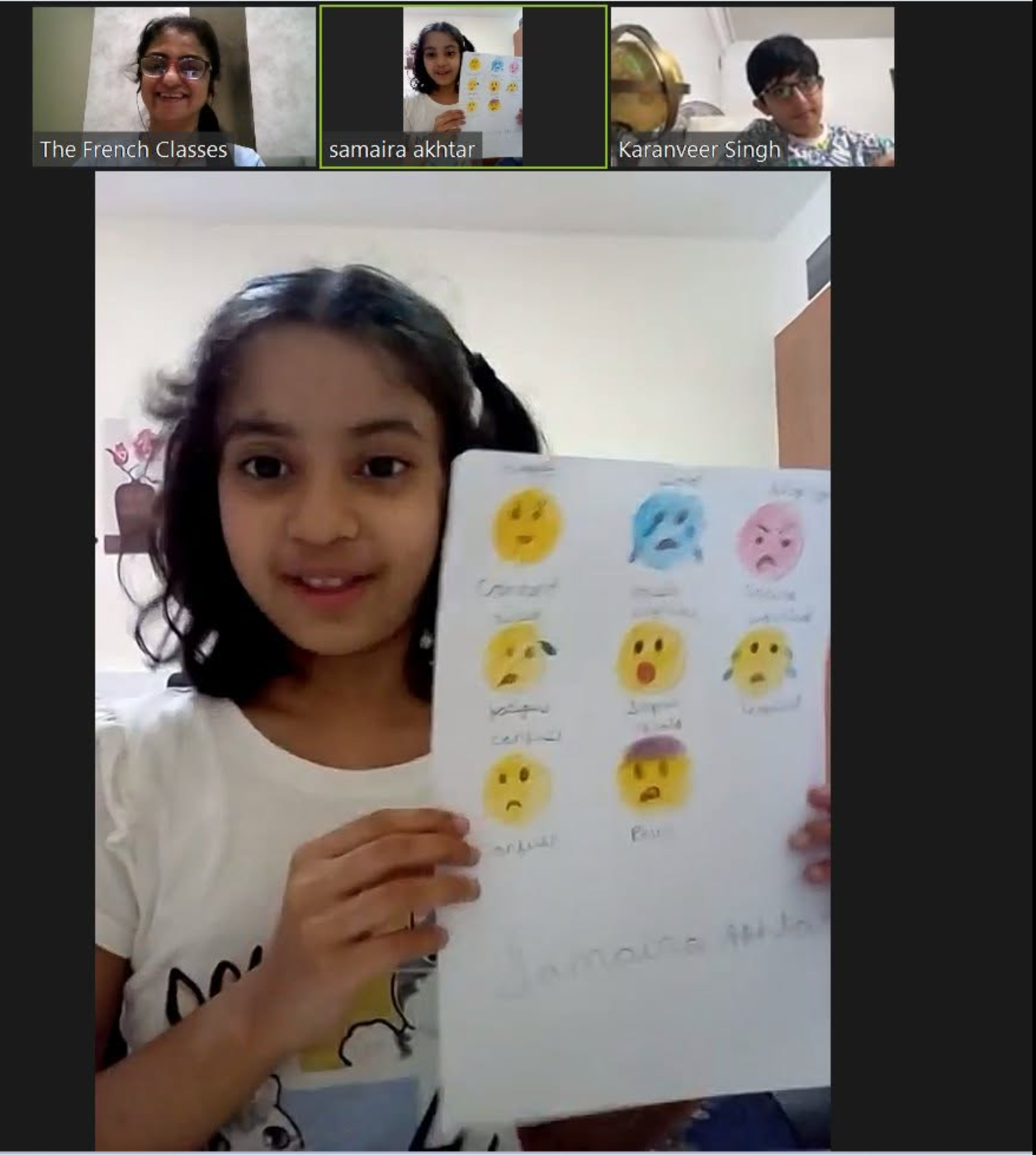 A student showing classwork during an online French lesson with Bhaveshi